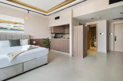 a bedroom with a bed and a kitchen at Luxury JLT Studio Renovated Lake View Metro in Dubai