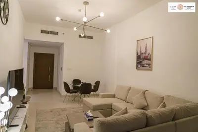 a living room with a couch and a table at Serenity 1 bdr with private garden in Dubai