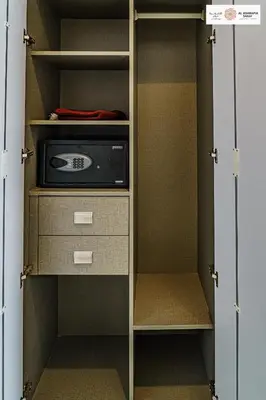 a closet with a door open with a microwave at Serenity 1 bdr with private garden in Dubai