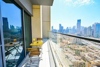 a balcony with chairs and a view of a city at BEST Burj Khalifa View 2br 3 beds in Dubai