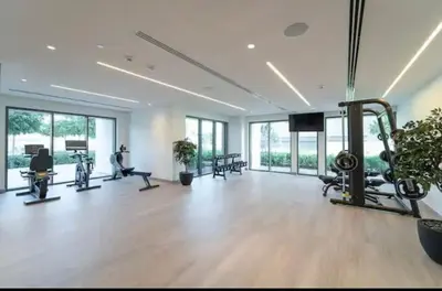 a gym with treadmills and machines in a room with windows at BEST Burj Khalifa View 2br 3 beds in Dubai