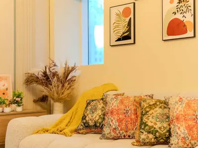 a living room with a couch with pillows on it at Superb 2BR Prime Locale between Dubai Marina JBR in Dubai