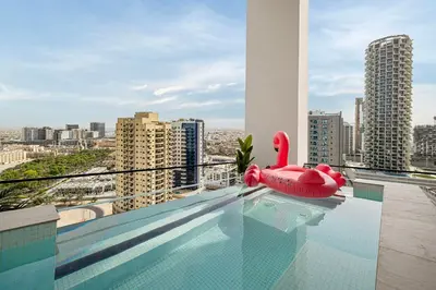 a swimming pool with a red swan float on top of a building at Private Pool! Exceptional 2 Bedroom! Brand New Building with Pool and Gym! in Dubai