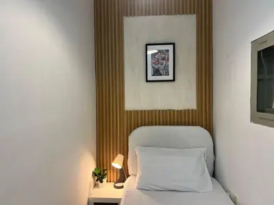 a bedroom with a bed and a picture on the wall at Minimalist Room In Al Barsha 1 Near Mall of Emirates in Dubai