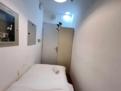 a small room with a bed and a door at Elite Single Suite Room Partition In Tecom in Dubai