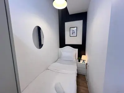 a small room with a bed and a mirror at Comfort Nock Partition Room Near Mall Of emirates in Dubai