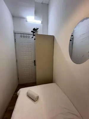 a small room with a bed and a mirror at Comfort Nock Partition Room Near Mall Of emirates in Dubai