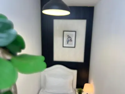 a room with a bed and a picture on the wall at Comfort Nock Partition Room Near Mall Of emirates in Dubai
