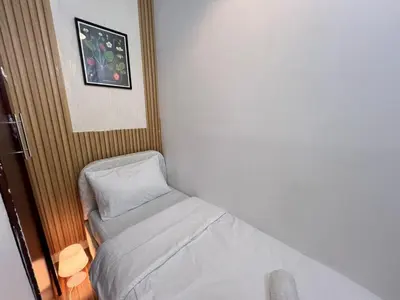 a small room with a bed and a pillow at Solo space Partition room In Barsha Heights Tecom in Dubai