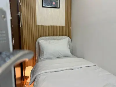 a small room with a bed and a chair at Solo space Partition room In Barsha Heights Tecom in Dubai