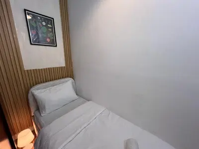 a small room with a bed and a pillow at Solo space Partition room In Barsha Heights Tecom in Dubai