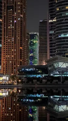 a view of a city at night with tall buildings at Studio-Like Private Bedroom with Balcony & Private Washroom in JLT in Dubai