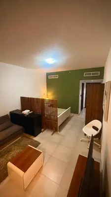 a living room with a couch and a table at Studio-Like Private Bedroom with Balcony & Private Washroom in JLT in Dubai
