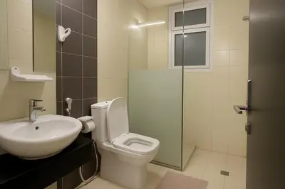 a bathroom with a toilet and a sink and a shower at The S Royal Marina Boutique Stay For Ladies And Families Only in Dubai