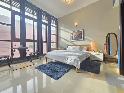 a bedroom with a large bed and a mirror at Efficiancy studio 6mins walk to metro Near DWTC in Dubai