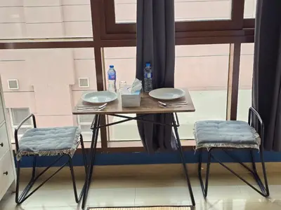 a table and two chairs in front of a window at Efficiancy studio 6mins walk to metro Near DWTC in Dubai