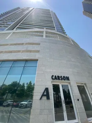a building with a sign on the front of it at Modern DAMAC Hills Studio with Balcony, Gym & Pool in Dubai