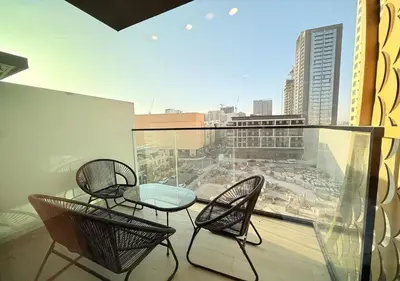 a balcony with two chairs and a table on a balcony at Binghatti Crescent Cozy 2 BR in Dubai
