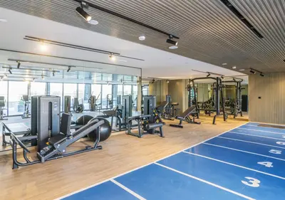 a gym with treadmills and cardio equipment in a building at Binghatti Crescent Cozy 2 BR in Dubai
