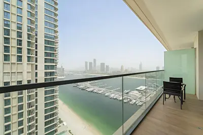 a balcony with a table and a view of a harbor at Silkhaus Seaside Bliss 1BDR in Marina Vista in Dubai