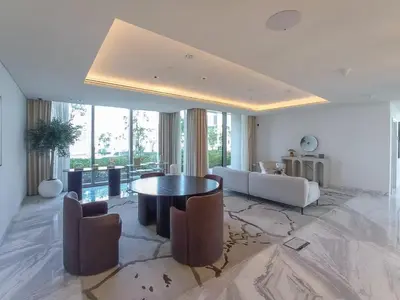 a large living room with a table and chairs at Sunset Sea View at 5242 Emaar in Dubai