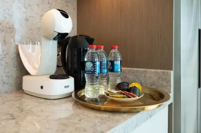 a counter with bottles of water and a coffee maker at KeyRock - Palm & Sea View Retreat with Pool Access in Dubai