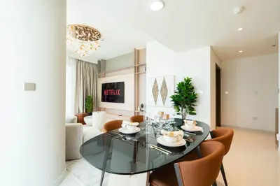 a dining room with a glass table and chairs at KeyRock - Palm & Sea View Retreat with Pool Access in Dubai