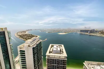 an aerial view of a large body of water with buildings at Luxury 3BR Palm Views at Emaar Beachfront in Dubai