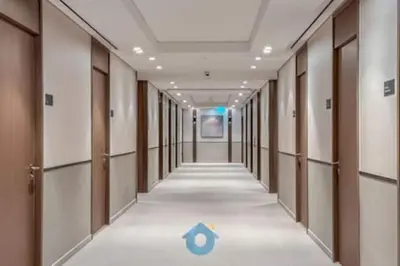 a hallway with a blue arrow on the floor at Next to Burj Khalifa & Dubai Mall - Luxury 2BR with Dubai Skyline Views - Like Home in Dubai