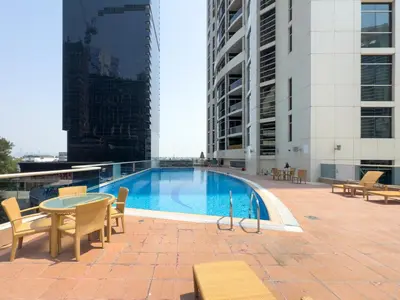 a swimming pool on the roof of a building at GuestReady - High Floor | Canal View Near Dubai Marina in Dubai