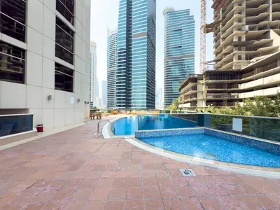 a swimming pool in a city with tall buildings at GuestReady - High Floor | Canal View Near Dubai Marina in Dubai