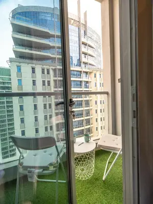 a balcony with a table and a chair and a window at Best location in Marina & jbr and marina view 1 minute from JBR in Dubai