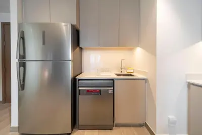 a kitchen with a stainless steel refrigerator and a sink at Ultra Luxuary 2BR - Creek Beach - Serenity Living in Dubai