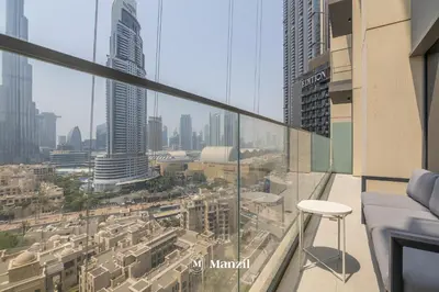 a balcony with a view of a city at Luxury 2BR Apartment in Downtown with Full Burj Khalifa View in Dubai