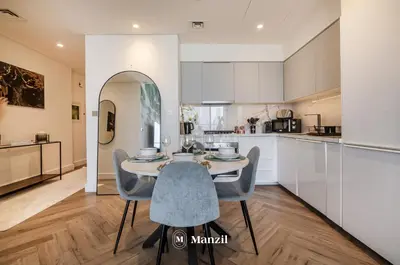 a kitchen and dining room with a table and chairs at Luxury 2BR Apartment in Downtown with Full Burj Khalifa View in Dubai