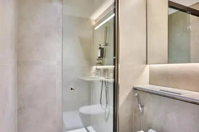 a bathroom with a shower and a toilet and a sink at STAY BY LATINEM Luxury 2BR Holiday Home CVG 907 Near Burj Khalifa in Dubai