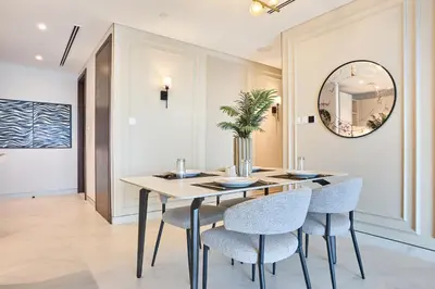 a dining room with a table with chairs and a mirror at STAY BY LATINEM Luxury 2BR Holiday Home CVG 907 Near Burj Khalifa in Dubai