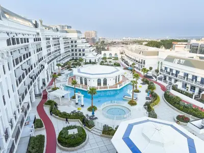 an aerial view of a resort with a pool and buildings at 1BR Lagoon View Luxury Spa Retreat near Miracle Garden in Dubai