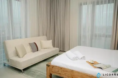 a living room with a bed and a couch at Brand New Modern 2 BR Retreat in Dubai Creek Harbour in Dubai