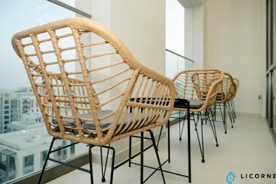 a group of chairs and a table in a room at Brand New Modern 2 BR Retreat in Dubai Creek Harbour in Dubai