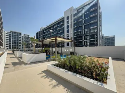 a courtyard in a city with tall buildings at Azizi Riviera - Chic Studio with Balcony in Meydan in Dubai