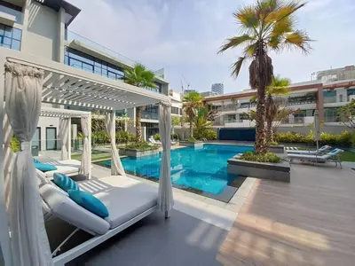a resort with a swimming pool and a hotel at Oxford Boulevard - Vibrant Studio in JVC in Dubai