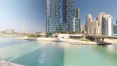 a view of a river in a city with tall buildings at 5242 Tower 2 - One Bed, Low Floor with Canal View in Dubai