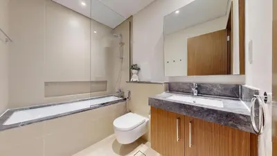a bathroom with a sink and a toilet and a mirror at 5242 Tower 2 - One Bed, Low Floor with Canal View in Dubai