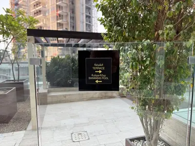 a fireplace with a sign on it in a building at ASHRI Luxury apt Steps to Dubai Mall & Burj Khalifa in Dubai