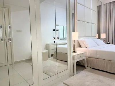 a bedroom with a bed and a bathroom with a mirror at ASHRI Luxury apt Steps to Dubai Mall & Burj Khalifa in Dubai