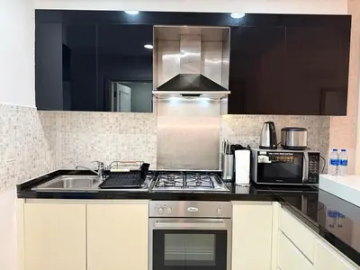 a kitchen with a sink and a stove top oven at ASHRI Luxury apt Steps to Dubai Mall & Burj Khalifa in Dubai
