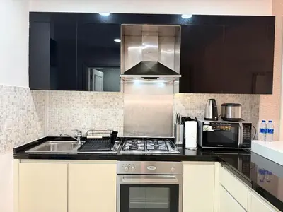 a kitchen with a sink and a stove top oven at ASHRI Luxury apt Steps to Dubai Mall & Burj Khalifa in Dubai