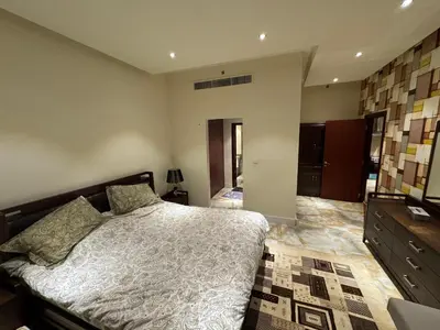 a bedroom with a bed and a dresser at Stylish 1BR JBR Beachfront in Dubai