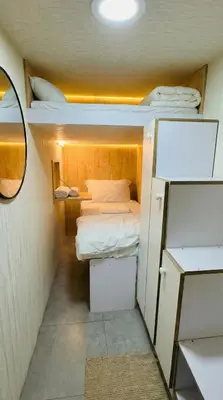 a small room with two bunk beds and a mirror at Modern Homestay Oval Tower, Business Bay in Dubai